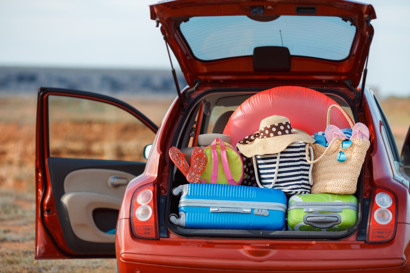 A car with an overflowing trunk